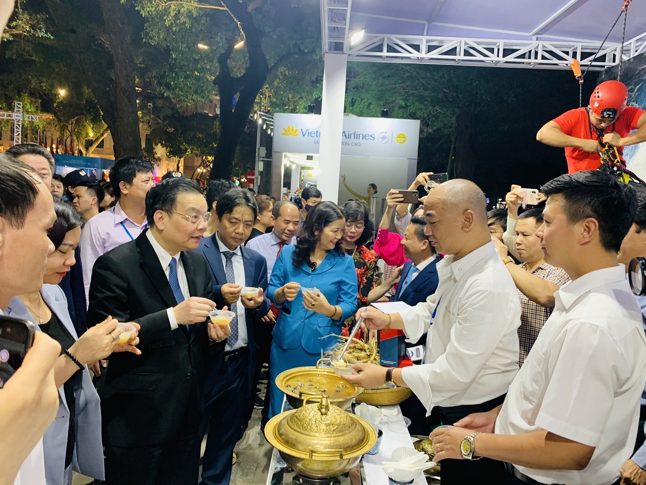 Chủ tịch UBND Thành phố Hà Nội Chu Ngọc Anh tham quan gian hàng du lịch Quảng Bình và thưởng thức món gà hầm sâm Tiến vua do Vua đầu bếp Phạm Tuấn Hải chế biến